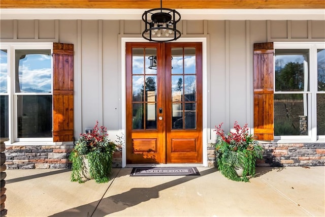 entrance to property featuring a porch and french doors