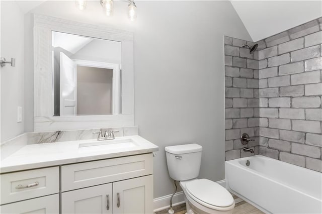 full bathroom with vanity, toilet, lofted ceiling, and tiled shower / bath