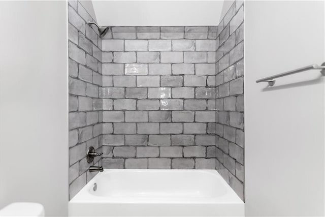 bathroom with toilet and washtub / shower combination