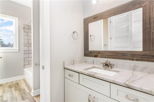 bathroom with wood-type flooring, vanity, and shower / tub combination