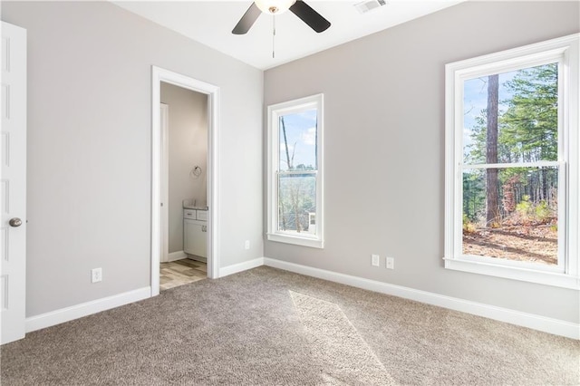 unfurnished bedroom featuring connected bathroom, ceiling fan, and light carpet