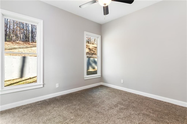 spare room featuring ceiling fan, plenty of natural light, and carpet