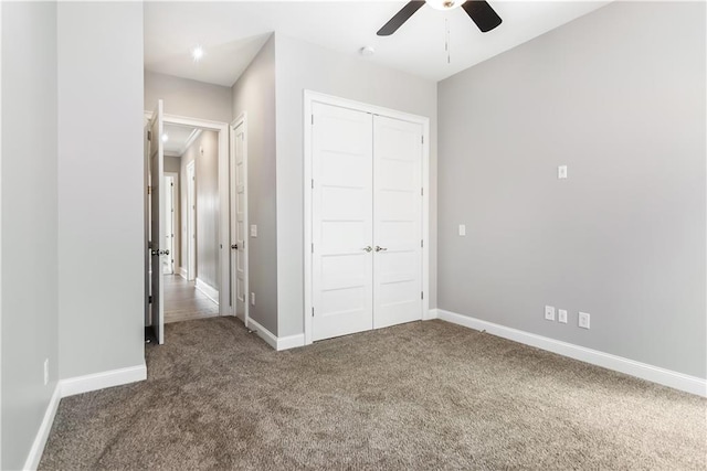 unfurnished bedroom featuring ceiling fan, a closet, and dark carpet