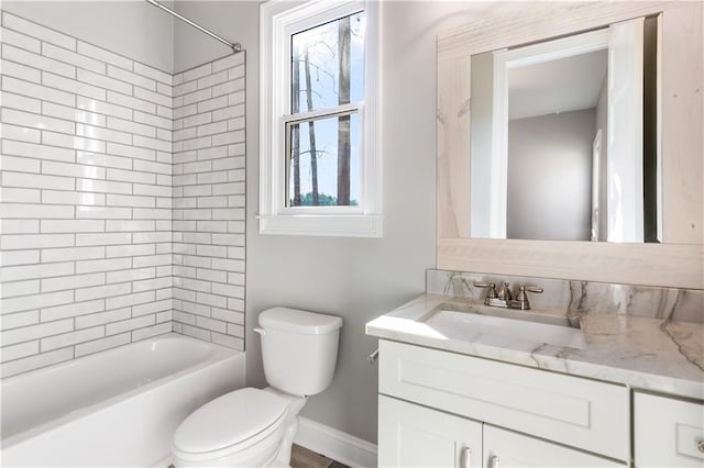 full bathroom featuring vanity, toilet, and tiled shower / bath