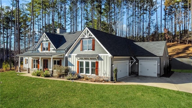 craftsman house with a porch, a garage, and a front yard