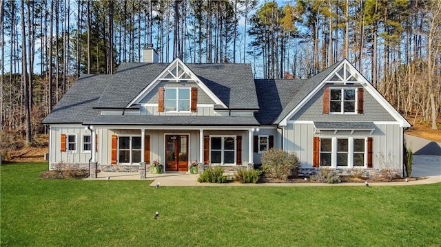 back of house featuring a yard and a porch