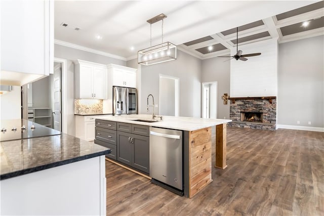 kitchen with appliances with stainless steel finishes, coffered ceiling, sink, gray cabinets, and white cabinetry