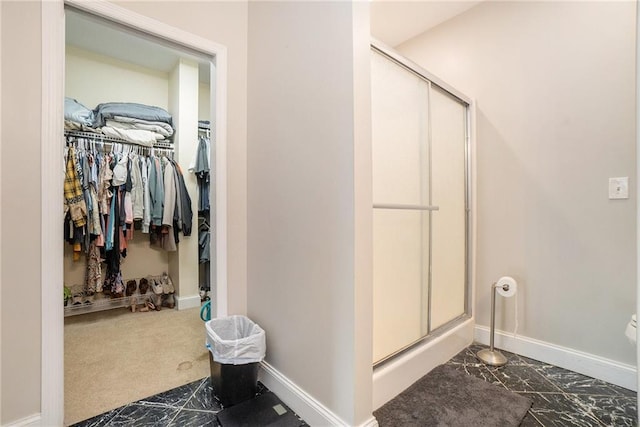 231 Gordon Rd, Cedartown, GA 30125 - bathroom with marble finish flooring, a stall shower, and a walk in closet