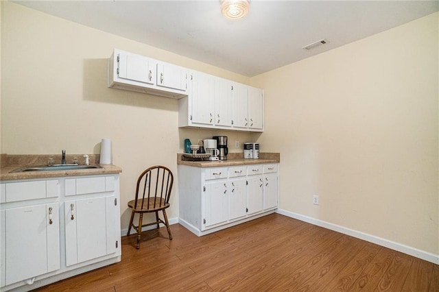 231 Gordon Rd, Cedartown, GA 30125 - kitchen with light wood finished floors, white cabinets, and light countertops