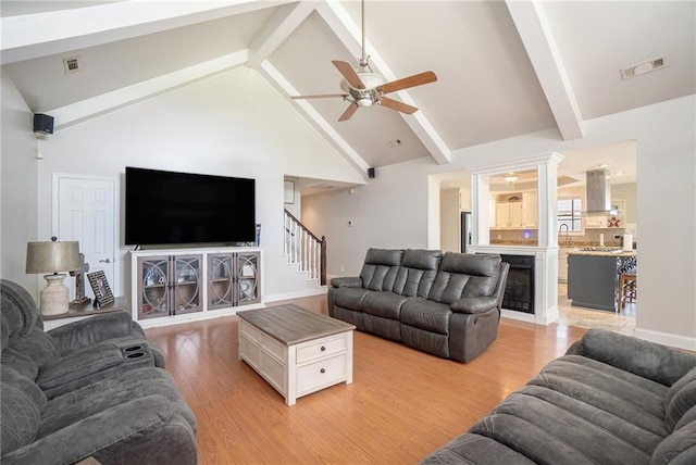 231 Gordon Rd, Cedartown, GA 30125 - living area with ceiling fan, light wood-style floors, stairway, beamed ceiling, and high vaulted ceiling