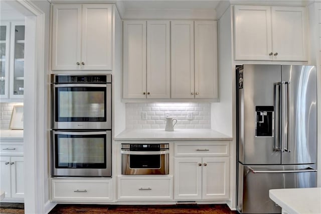 kitchen featuring light countertops, appliances with stainless steel finishes, and white cabinets