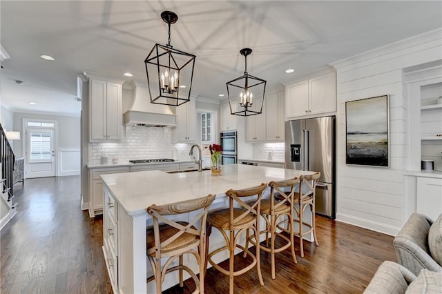 kitchen featuring dark wood-style flooring, crown molding, stainless steel appliances, light countertops, and a sink