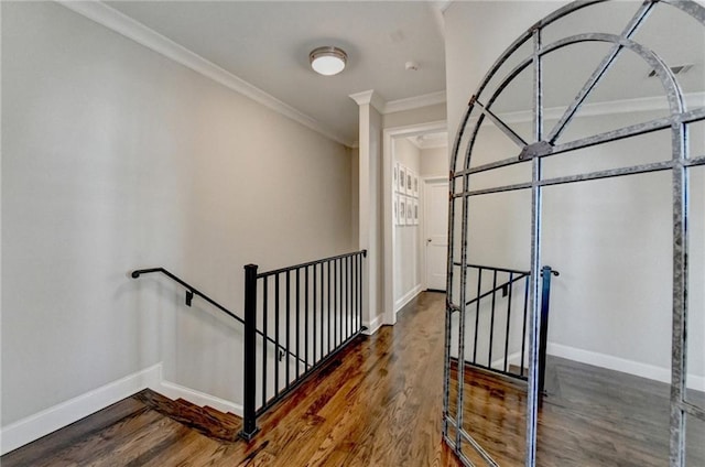 interior space with baseboards, an upstairs landing, and wood finished floors