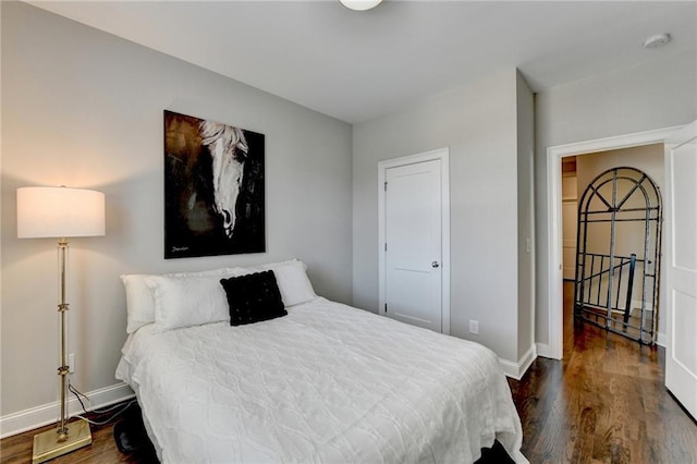 bedroom featuring baseboards and wood finished floors