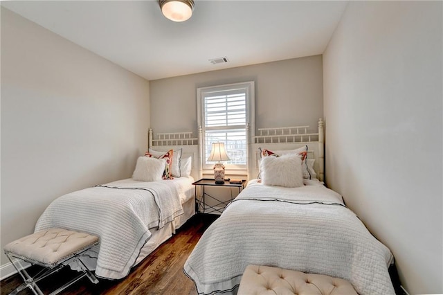 bedroom featuring dark wood finished floors and visible vents