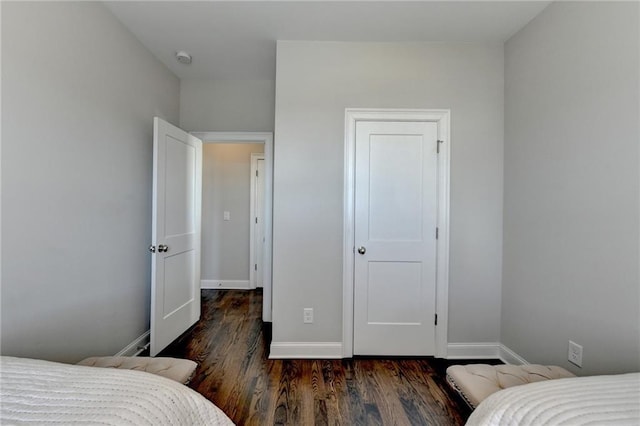 bedroom with dark wood-style floors and baseboards