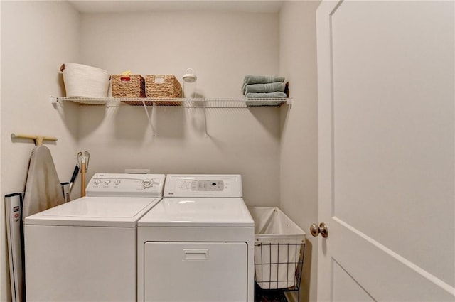 clothes washing area with laundry area and washer and clothes dryer