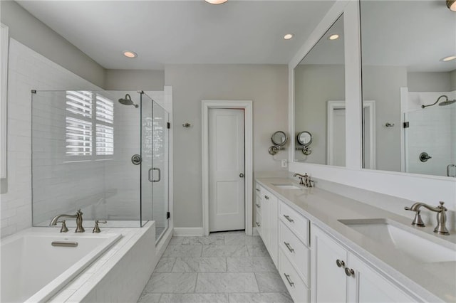 bathroom with marble finish floor, a garden tub, a sink, and a shower stall