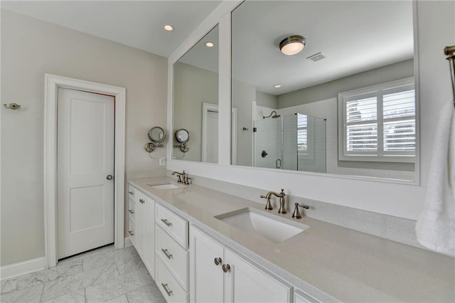 bathroom featuring marble finish floor, a stall shower, a sink, and visible vents