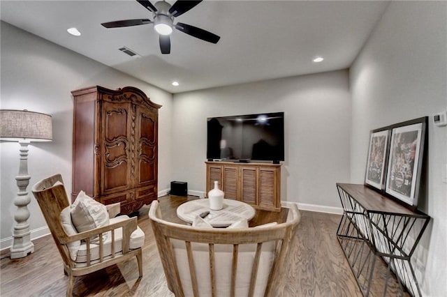 living area featuring recessed lighting, wood finished floors, a ceiling fan, visible vents, and baseboards