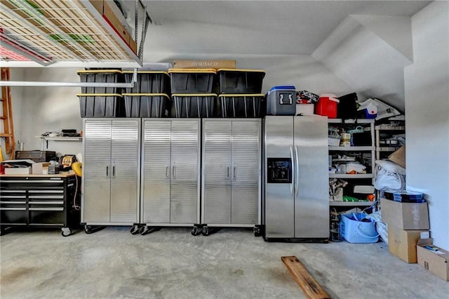 garage featuring stainless steel refrigerator with ice dispenser