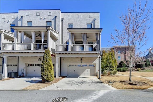 view of front of property with a garage, concrete driveway, and cooling unit