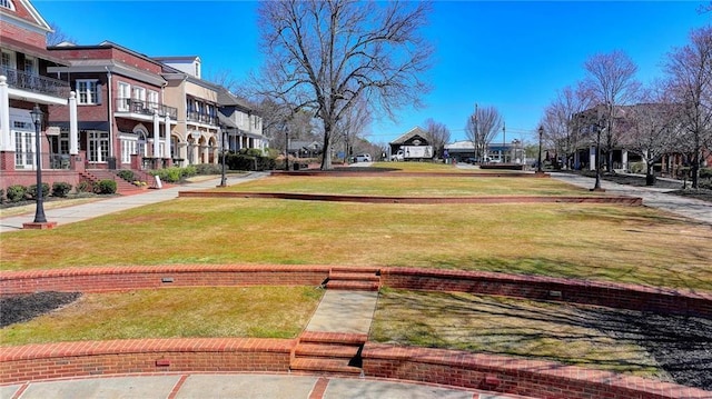 view of property's community featuring a residential view and a lawn