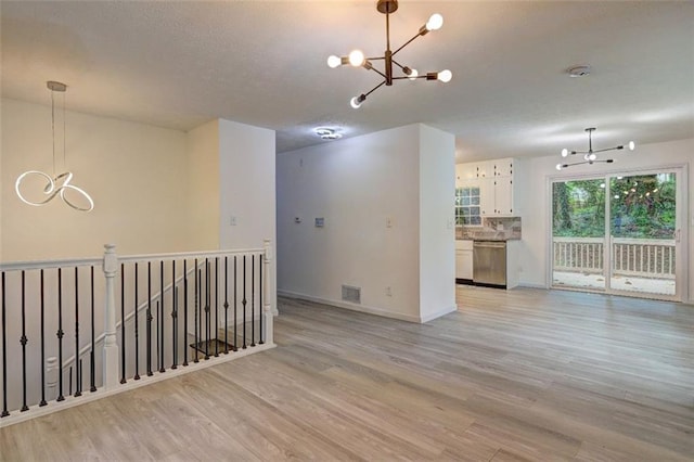 6454 Boca Grande Blvd, Forest Park, GA 30297 - empty room featuring a chandelier, light wood-style flooring, and baseboards