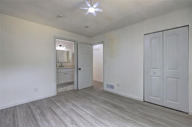 6454 Boca Grande Blvd, Forest Park, GA 30297 - unfurnished bedroom featuring light wood finished floors, a sink, baseboards, and a closet