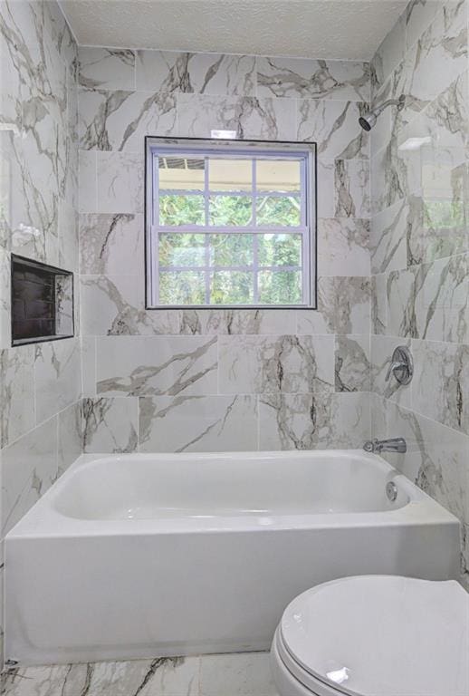 6454 Boca Grande Blvd, Forest Park, GA 30297 - bathroom featuring toilet, marble finish floors, a textured ceiling, and shower / tub combination