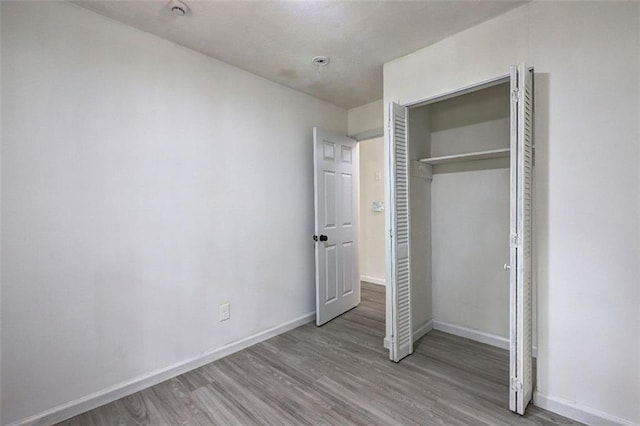 6454 Boca Grande Blvd, Forest Park, GA 30297 - unfurnished bedroom featuring wood finished floors, baseboards, and a closet