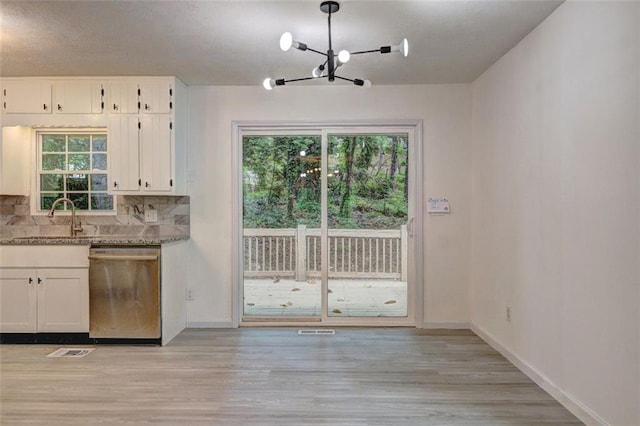 6454 Boca Grande Blvd, Forest Park, GA 30297 - kitchen with stainless steel dishwasher, a sink, a chandelier, white cabinetry, and light wood-style flooring