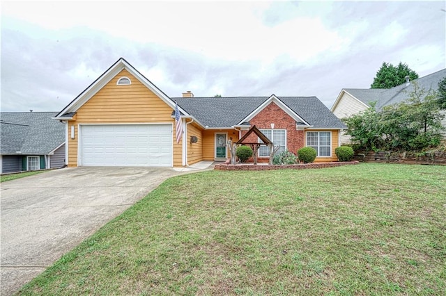 view of front of property with a front yard and a garage