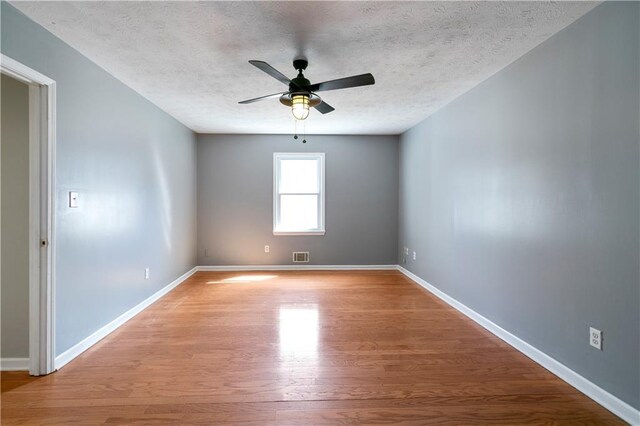 37 Indian Hills Ct, Dallas, GA 30157 - empty room with visible vents, light wood-style flooring, baseboards, and a textured ceiling
