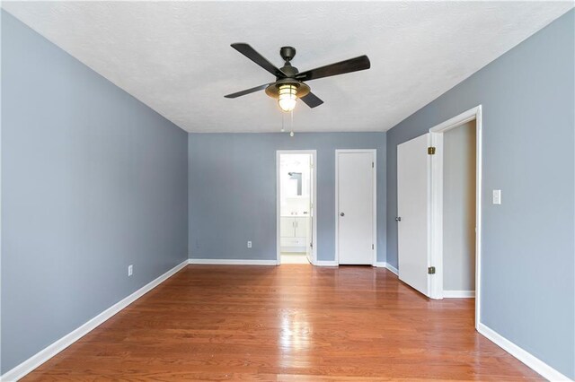 37 Indian Hills Ct, Dallas, GA 30157 - empty room with ceiling fan, a textured ceiling, wood finished floors, and baseboards