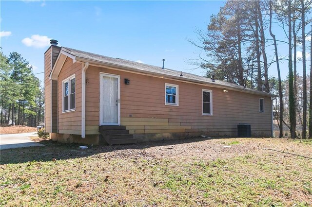 37 Indian Hills Ct, Dallas, GA 30157 - back of house with entry steps, a chimney, and cooling unit