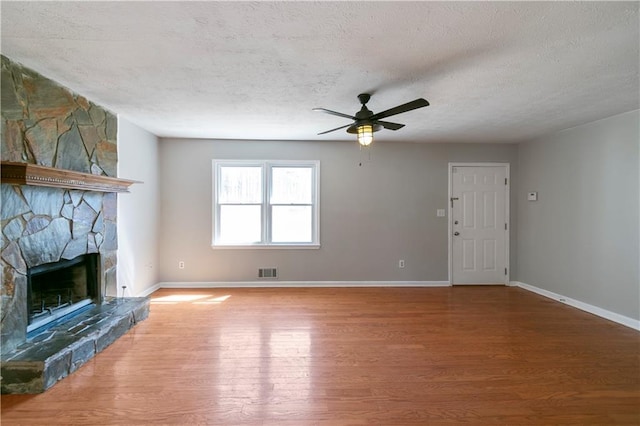 37 Indian Hills Ct, Dallas, GA 30157 - unfurnished living room featuring baseboards, visible vents, wood finished floors, a textured ceiling, and a fireplace