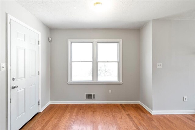 37 Indian Hills Ct, Dallas, GA 30157 - foyer featuring light wood-type flooring, visible vents, a textured ceiling, and baseboards