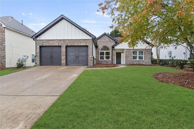 view of front of property featuring an attached garage, a front lawn, driveway, board and batten siding, and brick siding