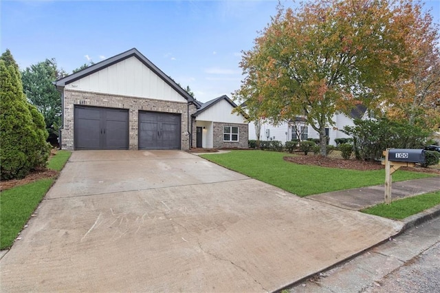 view of front of property with an attached garage, a front yard, driveway, and brick siding