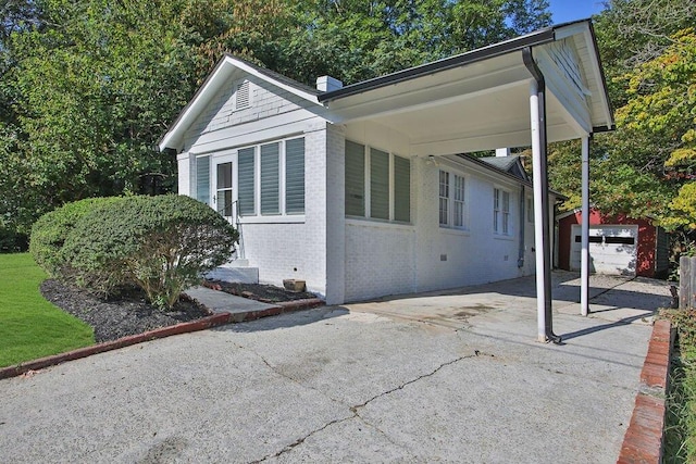 view of side of property featuring a garage and a carport