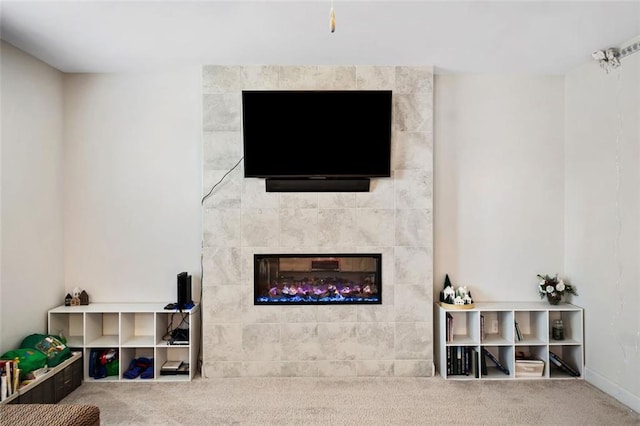 living room with carpet flooring and a fireplace