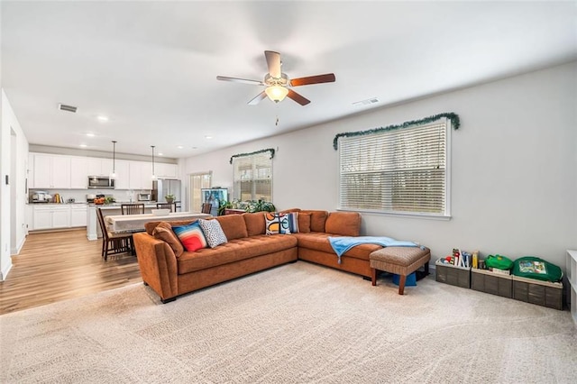 living room featuring visible vents, recessed lighting, light wood-style floors, and a ceiling fan