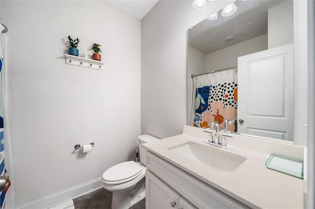 full bath with vanity, toilet, and baseboards