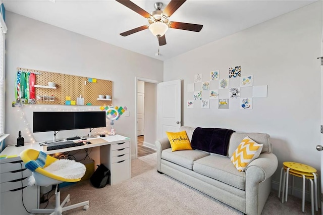 office space featuring light colored carpet and ceiling fan