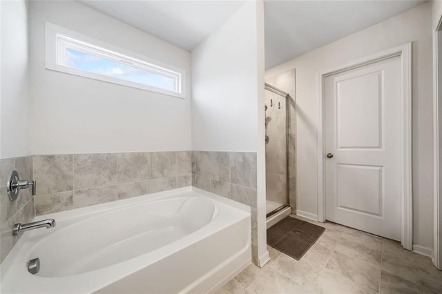 bathroom featuring a shower stall and a garden tub