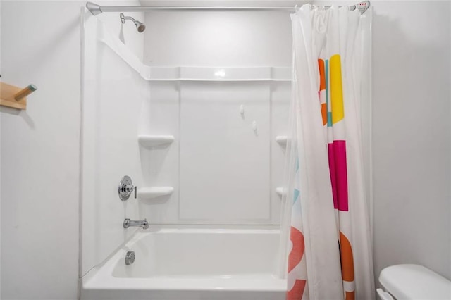 bathroom featuring shower / bathtub combination with curtain and toilet