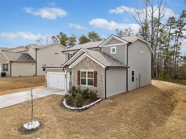 view of front facade with an attached garage, stone siding, and driveway