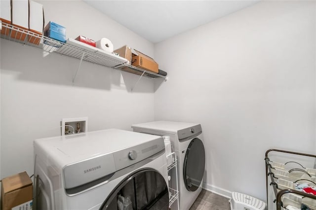 laundry room featuring washer and clothes dryer, laundry area, and baseboards