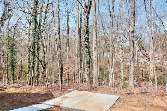 view of yard featuring a forest view